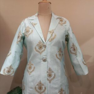 jacket in soft aqua blue, adorned with subtle gold block print motifs